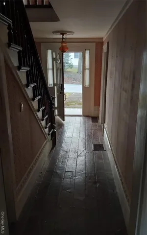 a view of entryway and hall with wooden floor