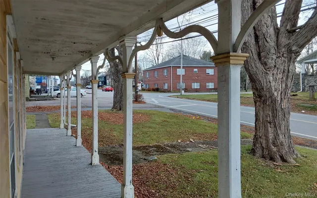 a view of a pathway of a house with a yard and fountain