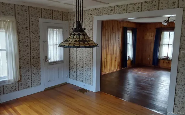 a view of a room with wooden floor and windows