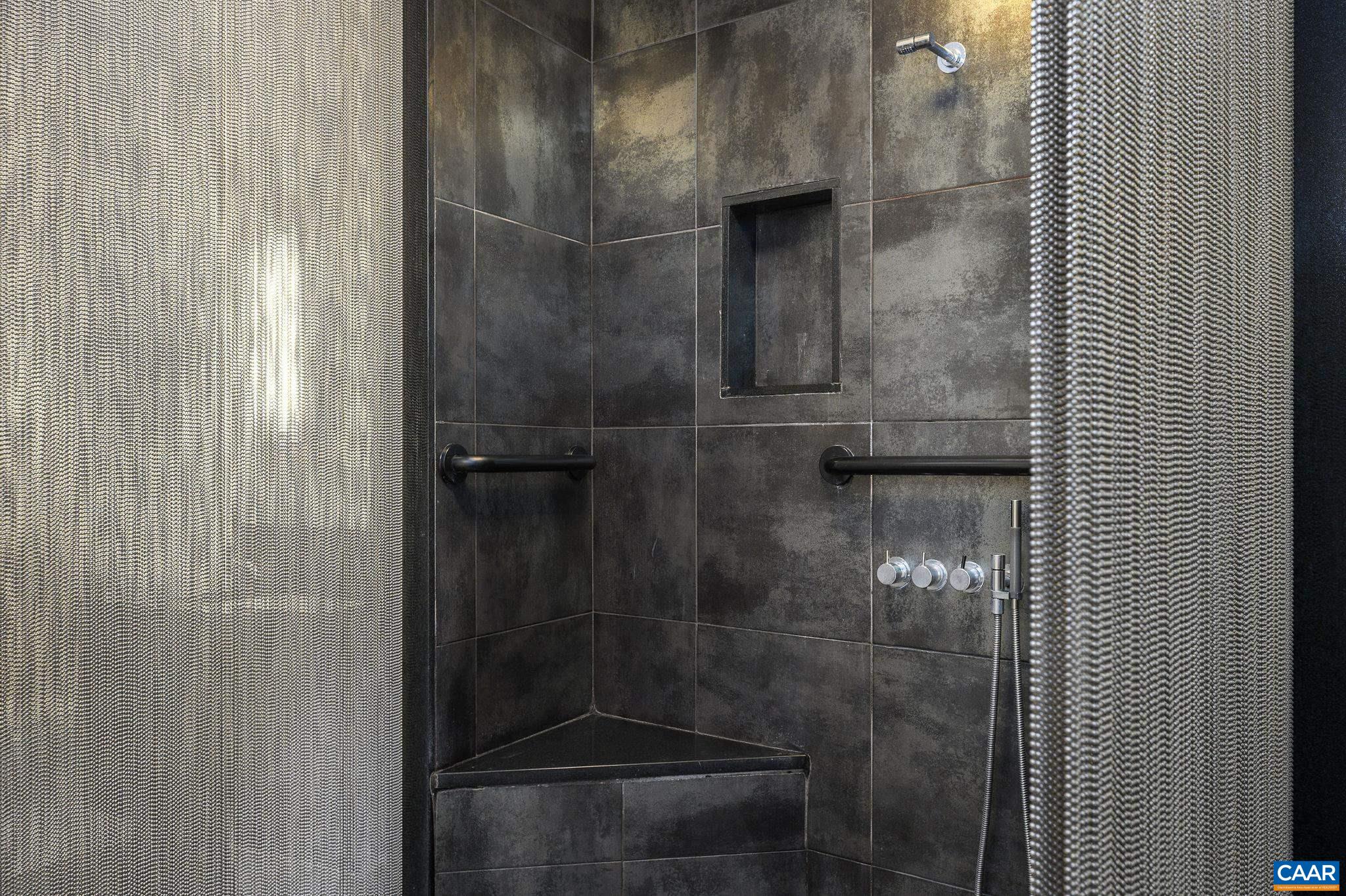 200 Garrett Street, Unit 515 Charlottesville, VA 22902 - Photo 16 of 31 a bathroom with a glass shower door
