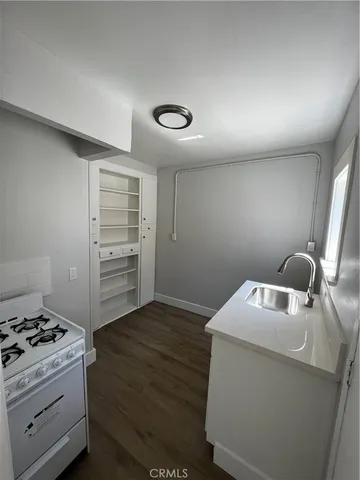 a kitchen with a stove and a cabinet