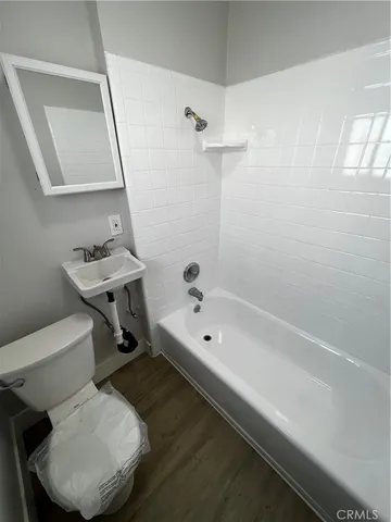 a bathroom with a sink a toilet and bathtub