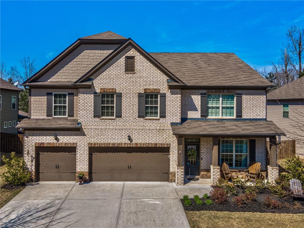 6440 Country Lake Road Cumming, GA 30041 - Photo 1 of 1 a front view of a house with a garden
