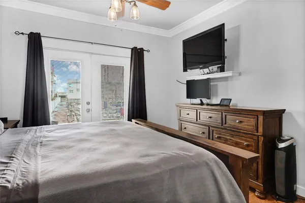 a bedroom with a bed and a flat screen tv