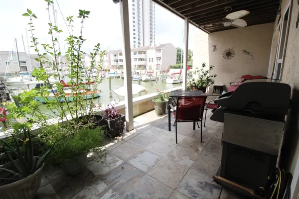 a balcony with furniture and a potted plant