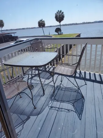 a roof deck with table and chairs