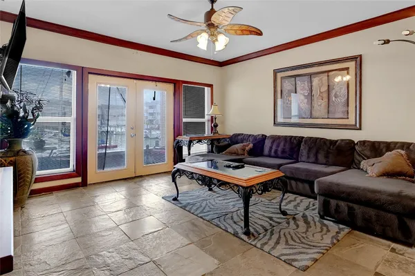 a living room with furniture a chandelier and a window