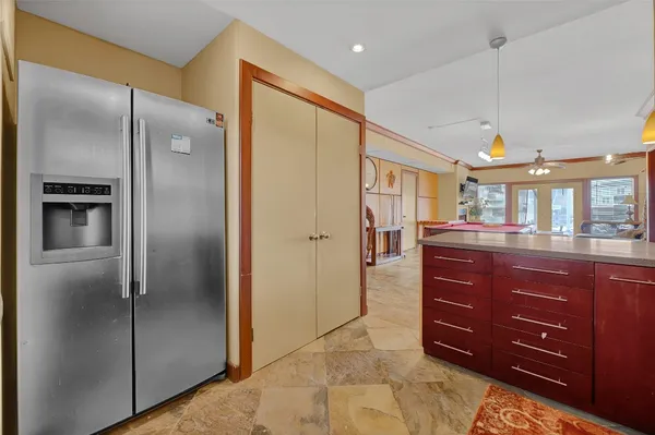 a kitchen with a refrigerator and cabinets