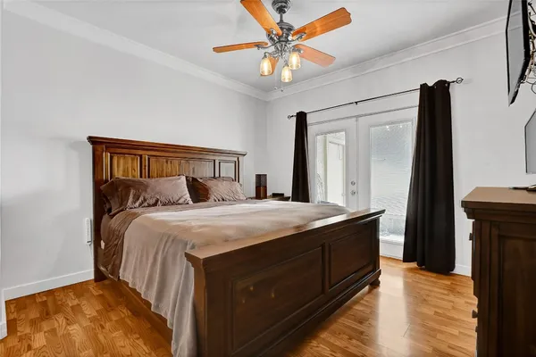 a bedroom with a bed and a chandelier