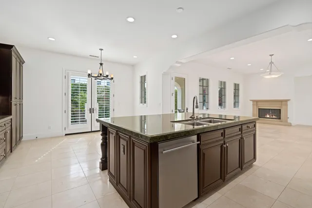 a kitchen with stainless steel appliances granite countertop a stove and a sink
