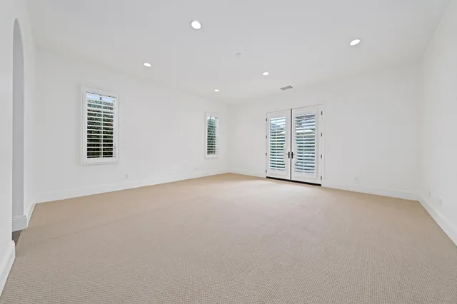 a view of a patio with table and chairs and potted plants