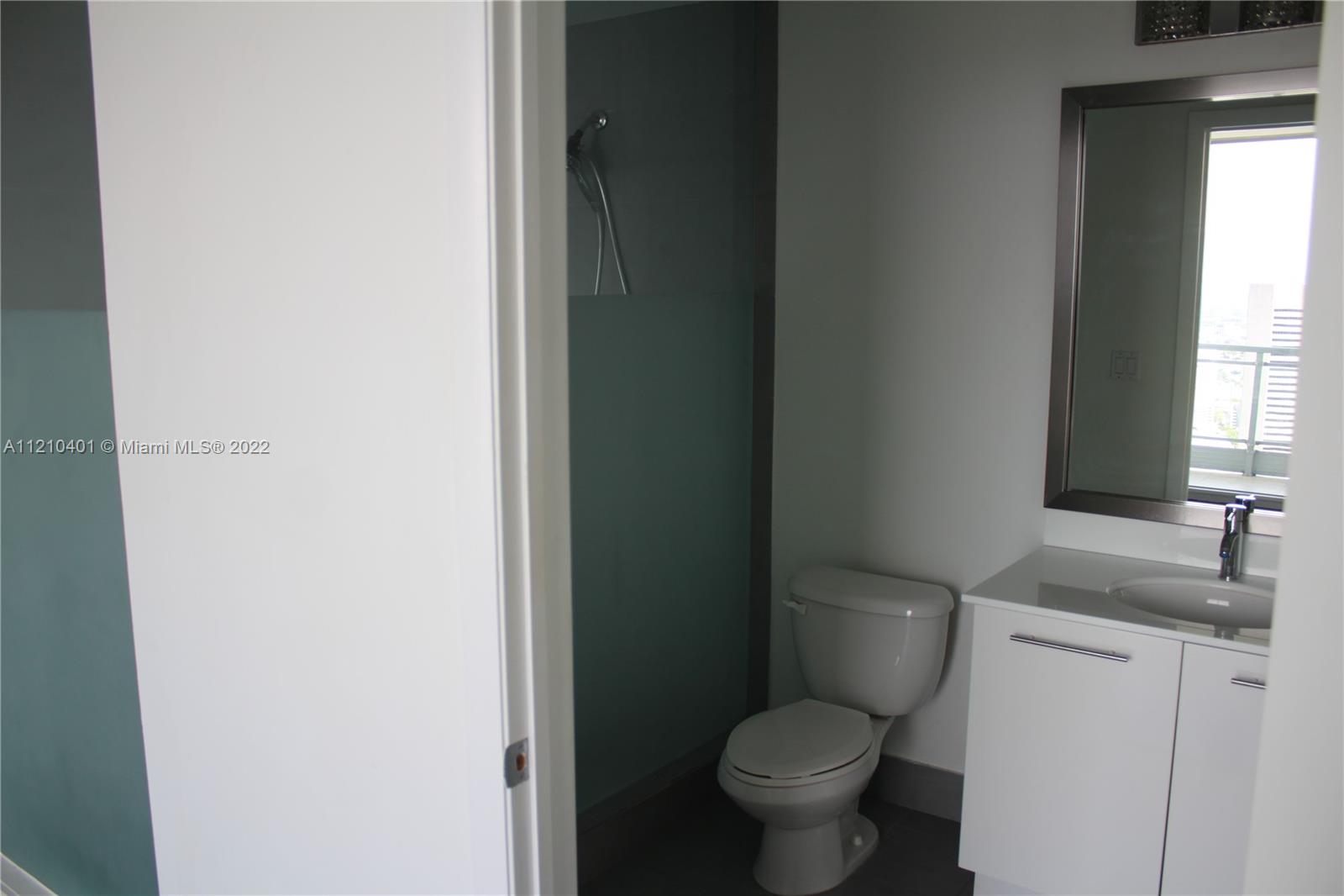 92 Southwest 3rd Street, Unit 5204 Miami, FL 33130 - Photo 11 of 20 a white toilet sitting next to a bathroom sink