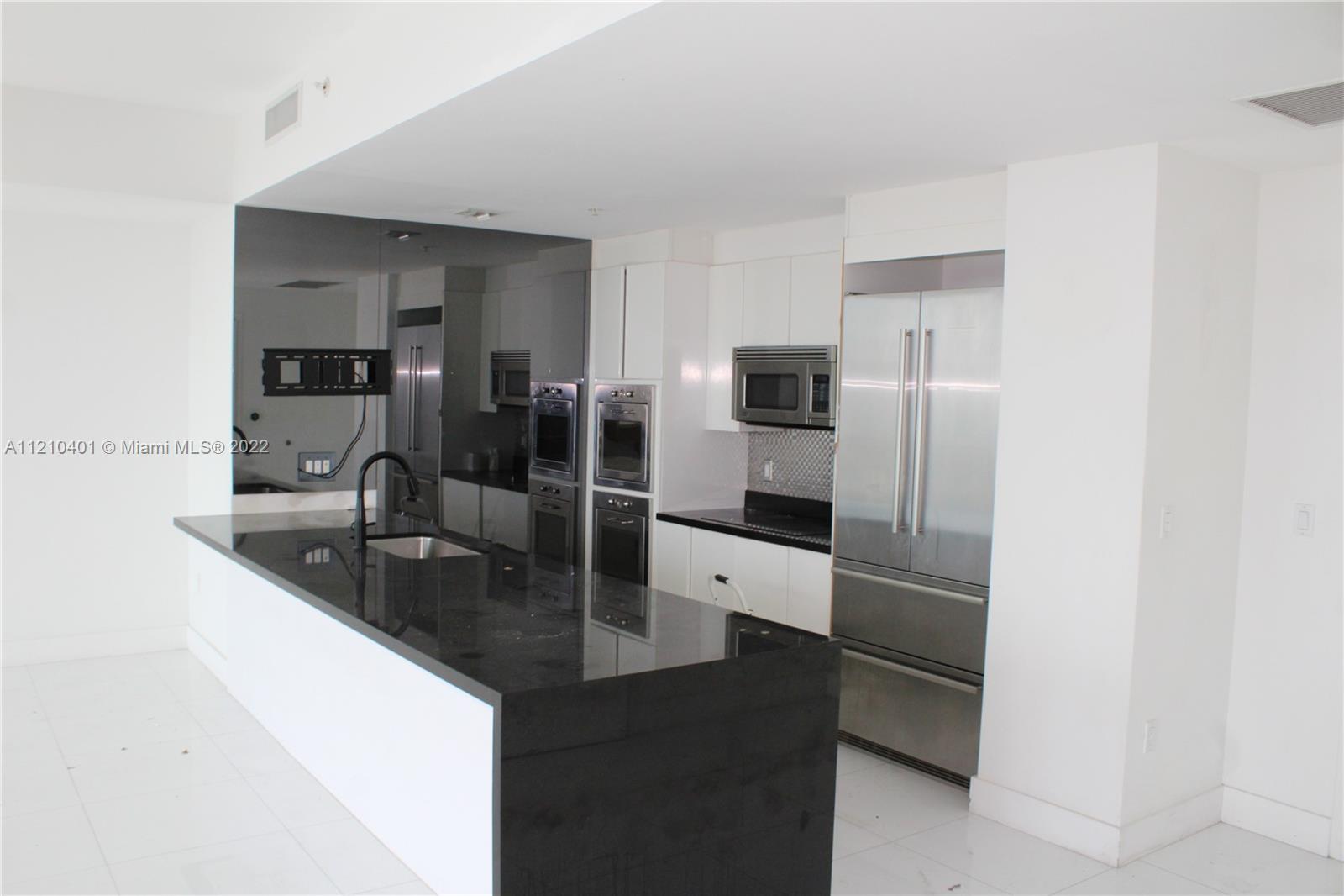 92 Southwest 3rd Street, Unit 5204 Miami, FL 33130 - Photo 5 of 20 a kitchen with stainless steel appliances granite countertop a sink and a refrigerator