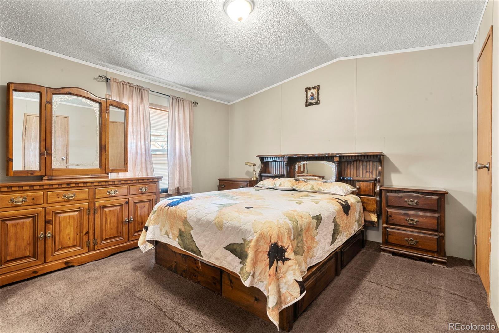 9850 Federal Boulevard Denver, CO 80260 - Photo 3 of 17 a bedroom with a bed and wooden floor