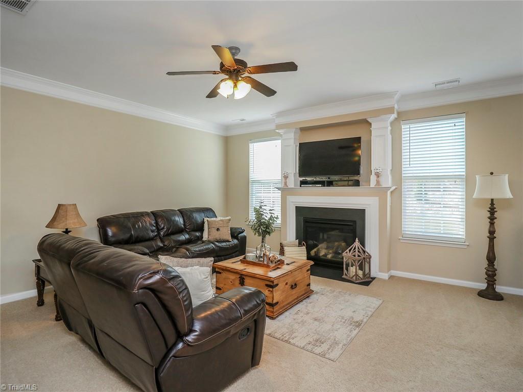 745 Spinning Wheel Point High Point, NC 27265 - Photo 14 of 34 Spacious living room with crown molding and recessed lighting.