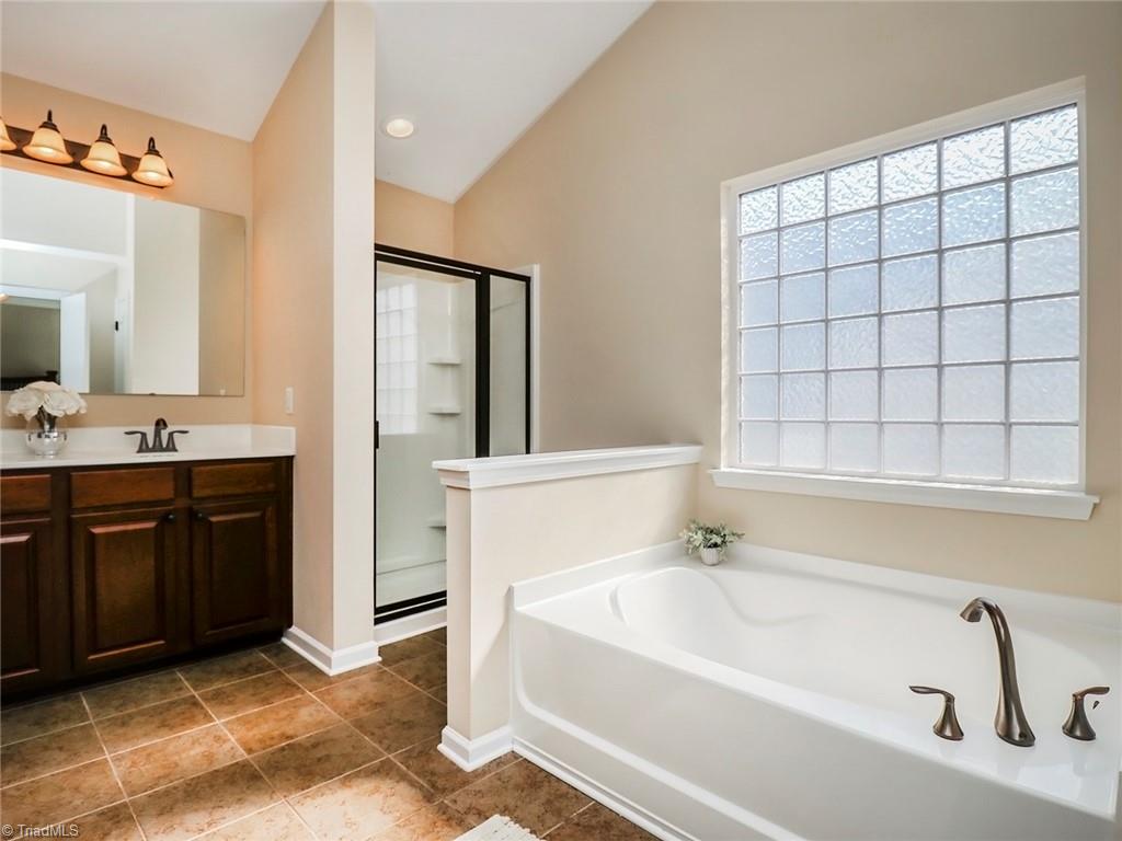 745 Spinning Wheel Point High Point, NC 27265 - Photo 19 of 34 Garden tub in primary bath with vaulted ceilings.