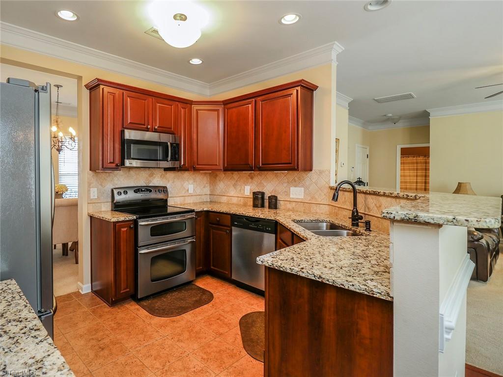 745 Spinning Wheel Point High Point, NC 27265 - Photo 4 of 34 Kitchen with great cabinet space, all stainless steel appliances, and granite counter tops.