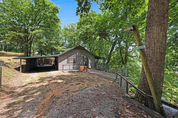 a wooden house with trees in front of it