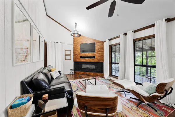 a living room with furniture fireplace and flat screen tv