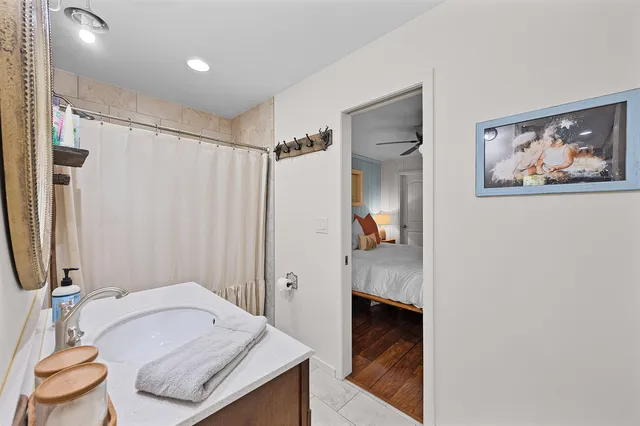 a bathroom with a granite countertop sink and a mirror
