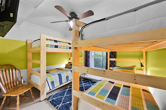 a bedroom with furniture and a large window