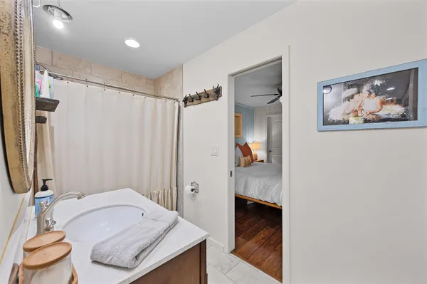 a bathroom with a granite countertop sink and a mirror