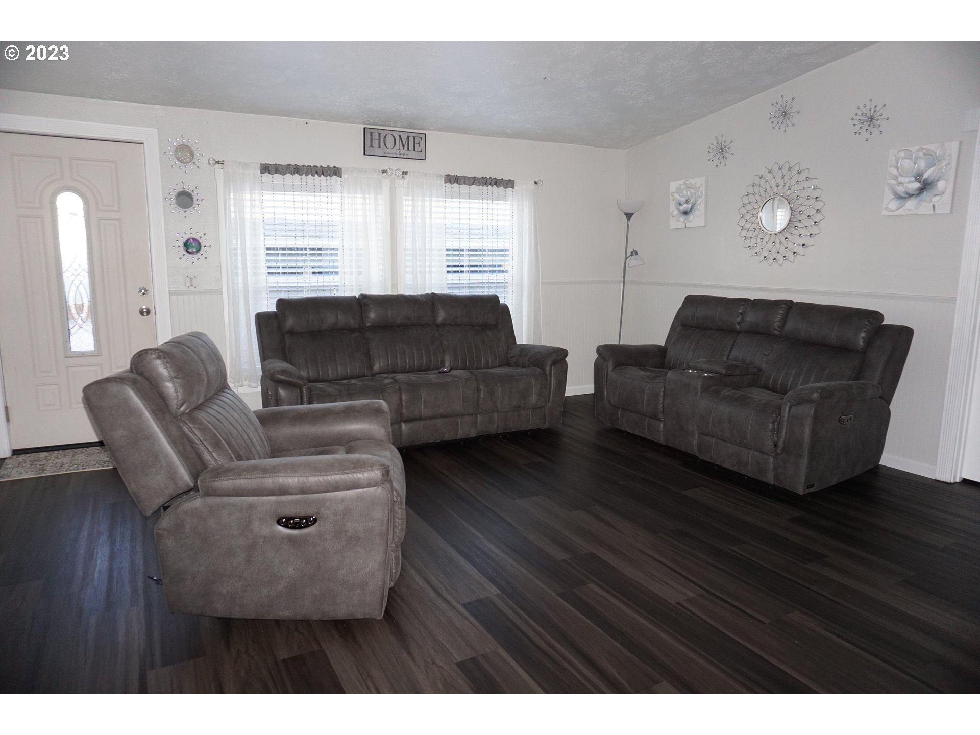 1949 Southeast Palmquist Road Gresham, OR 97080 - Photo 12 of 31 a living room with furniture and a wooden floor