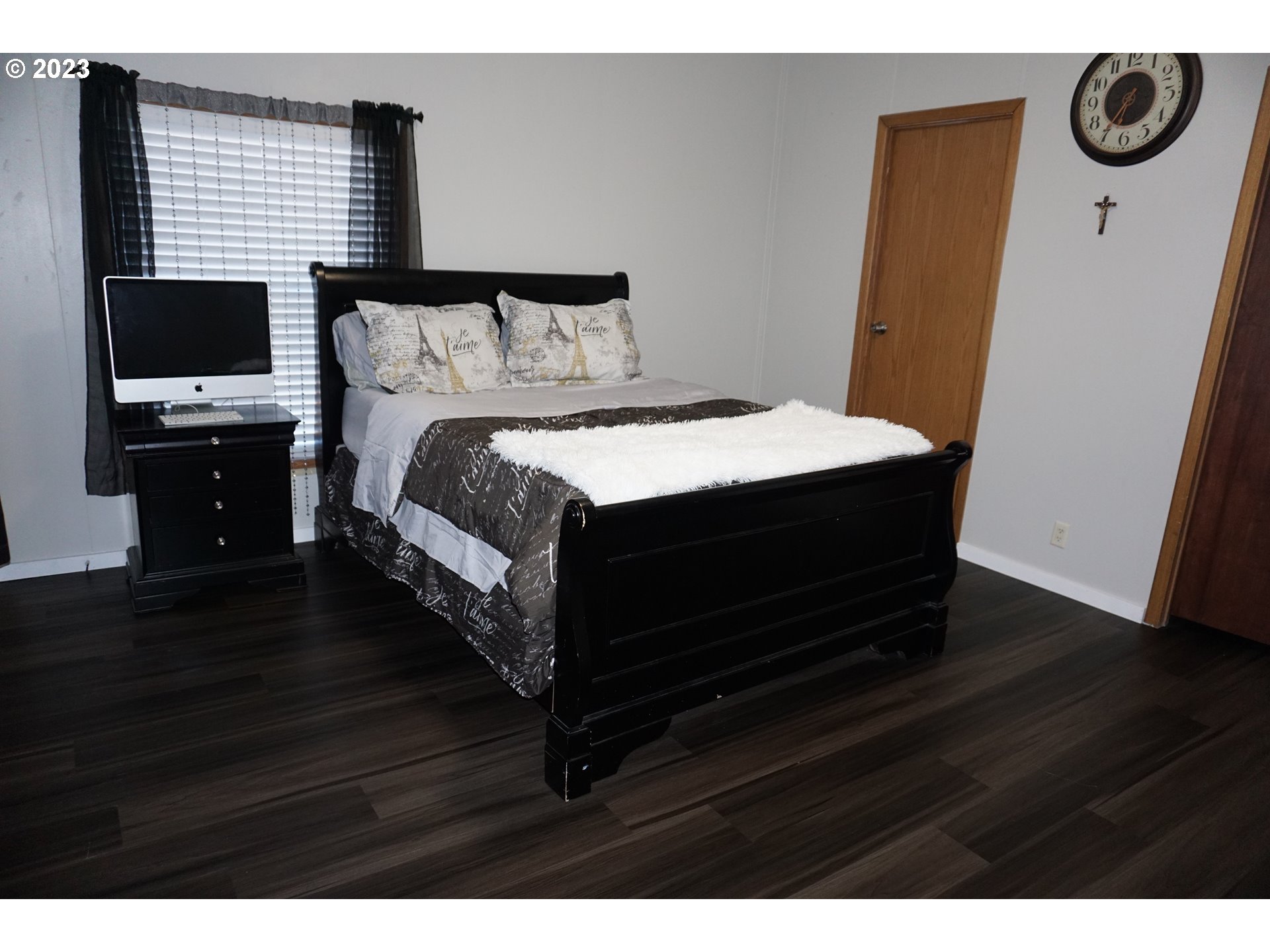 1949 Southeast Palmquist Road Gresham, OR 97080 - Photo 17 of 31 a bedroom with a bed and a flat tv screen on a dresser