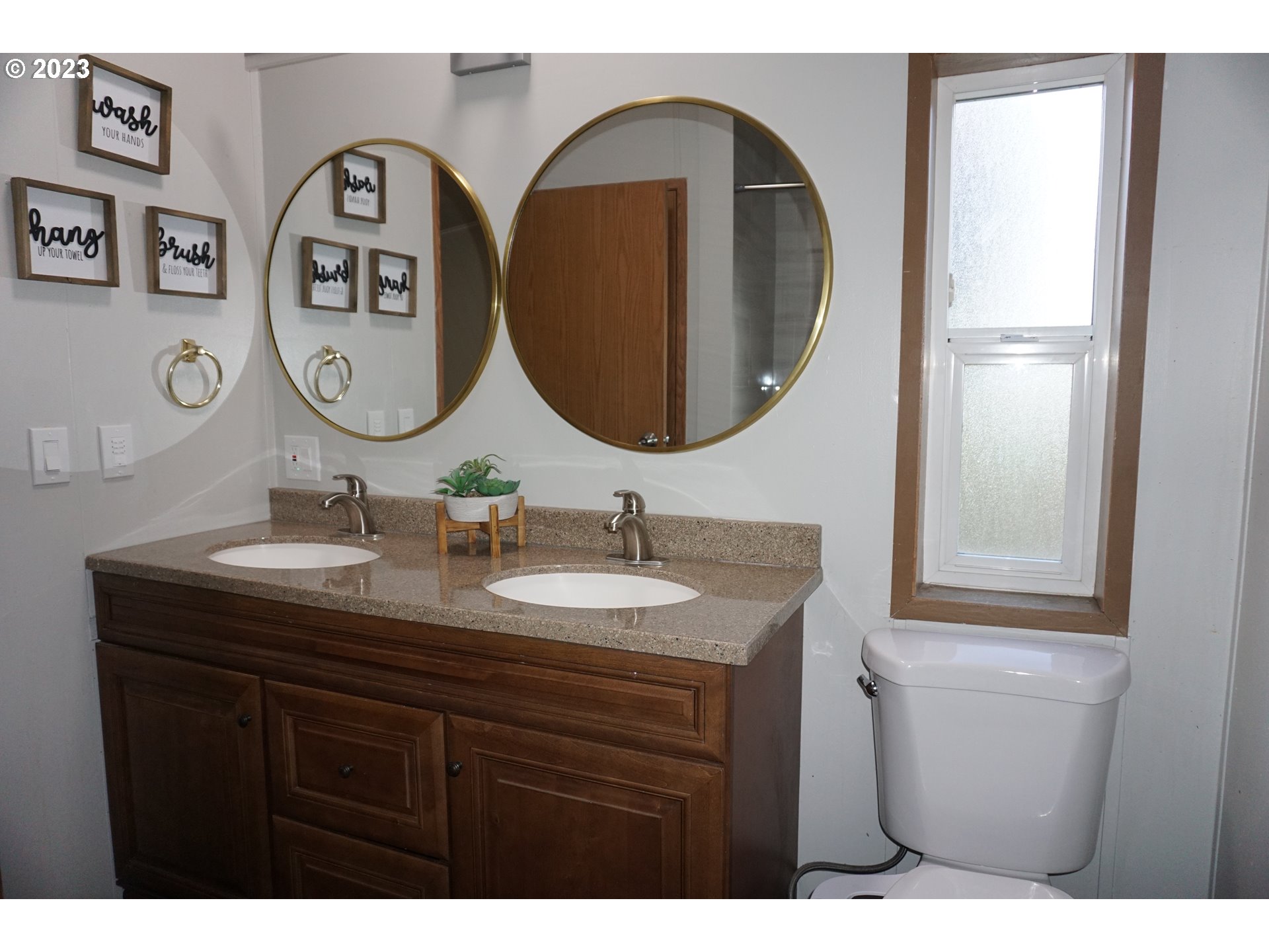 1949 Southeast Palmquist Road Gresham, OR 97080 - Photo 20 of 31 a bathroom with a granite countertop double vanity sink and a mirror