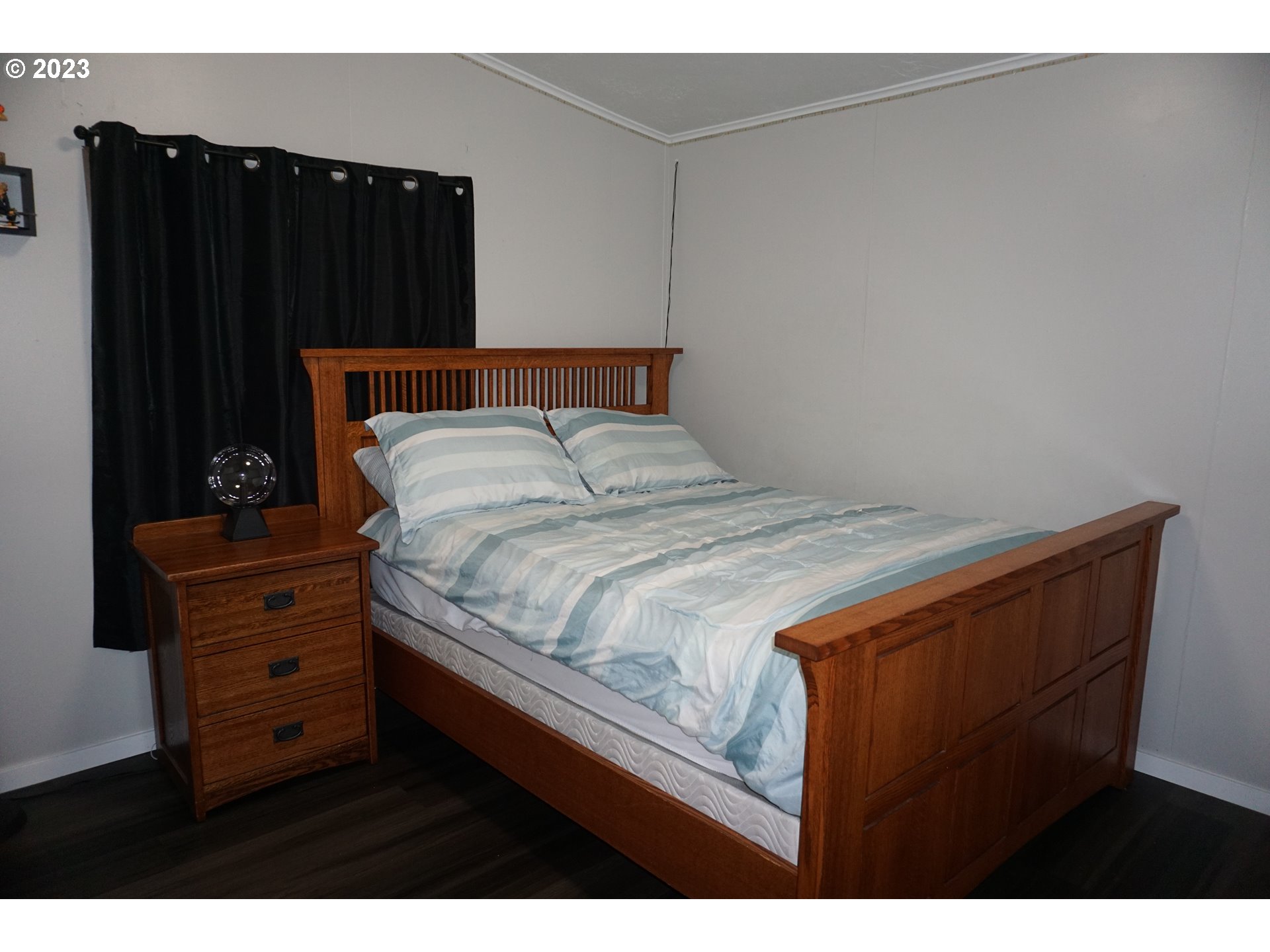 1949 Southeast Palmquist Road Gresham, OR 97080 - Photo 25 of 31 a bed sitting in a bedroom next to a cabinet