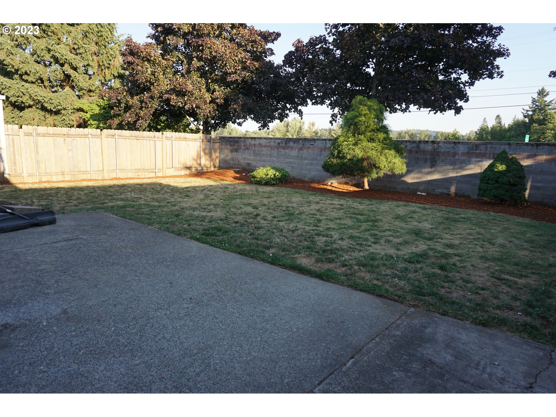 1949 Southeast Palmquist Road Gresham, OR 97080 - Photo 28 of 31 a backyard of a house with lots of green space