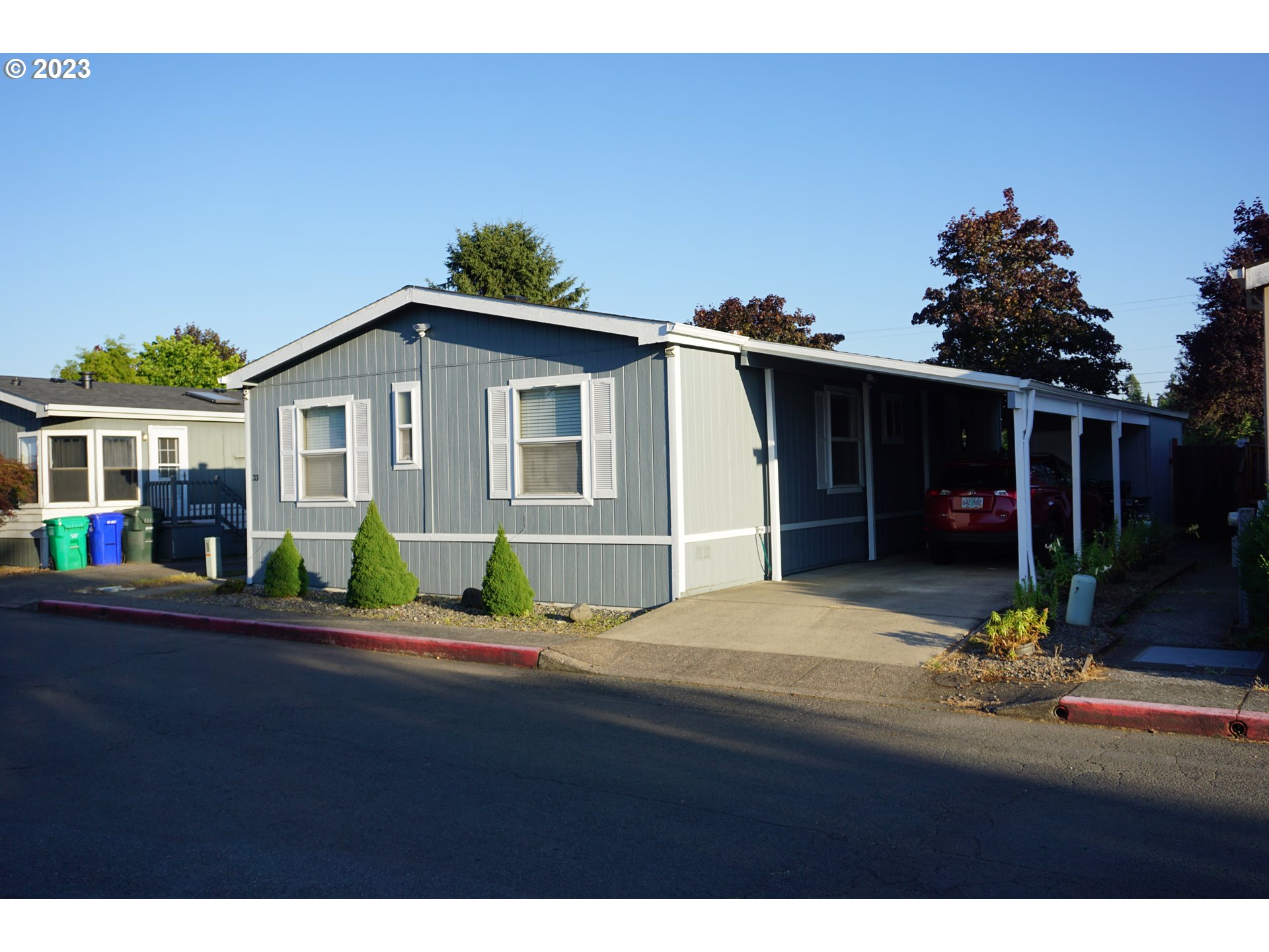 1949 Southeast Palmquist Road Gresham, OR 97080 - Photo 4 of 31 a front view of a house with a yard and potted plants
