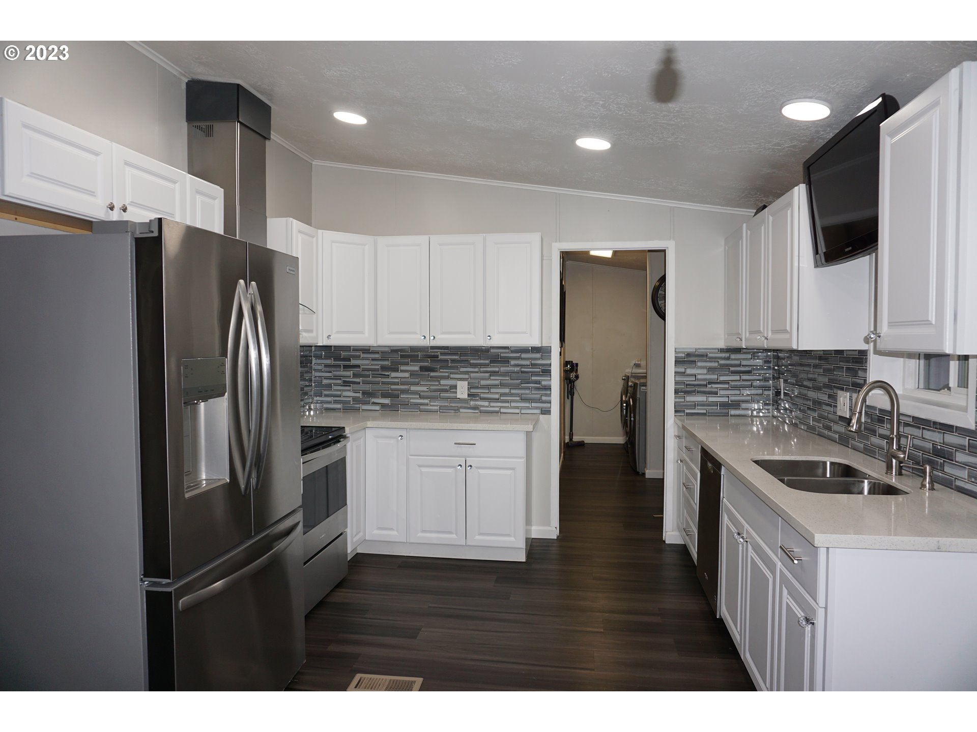 1949 Southeast Palmquist Road Gresham, OR 97080 - Photo 6 of 31 a kitchen with a refrigerator sink and cabinets