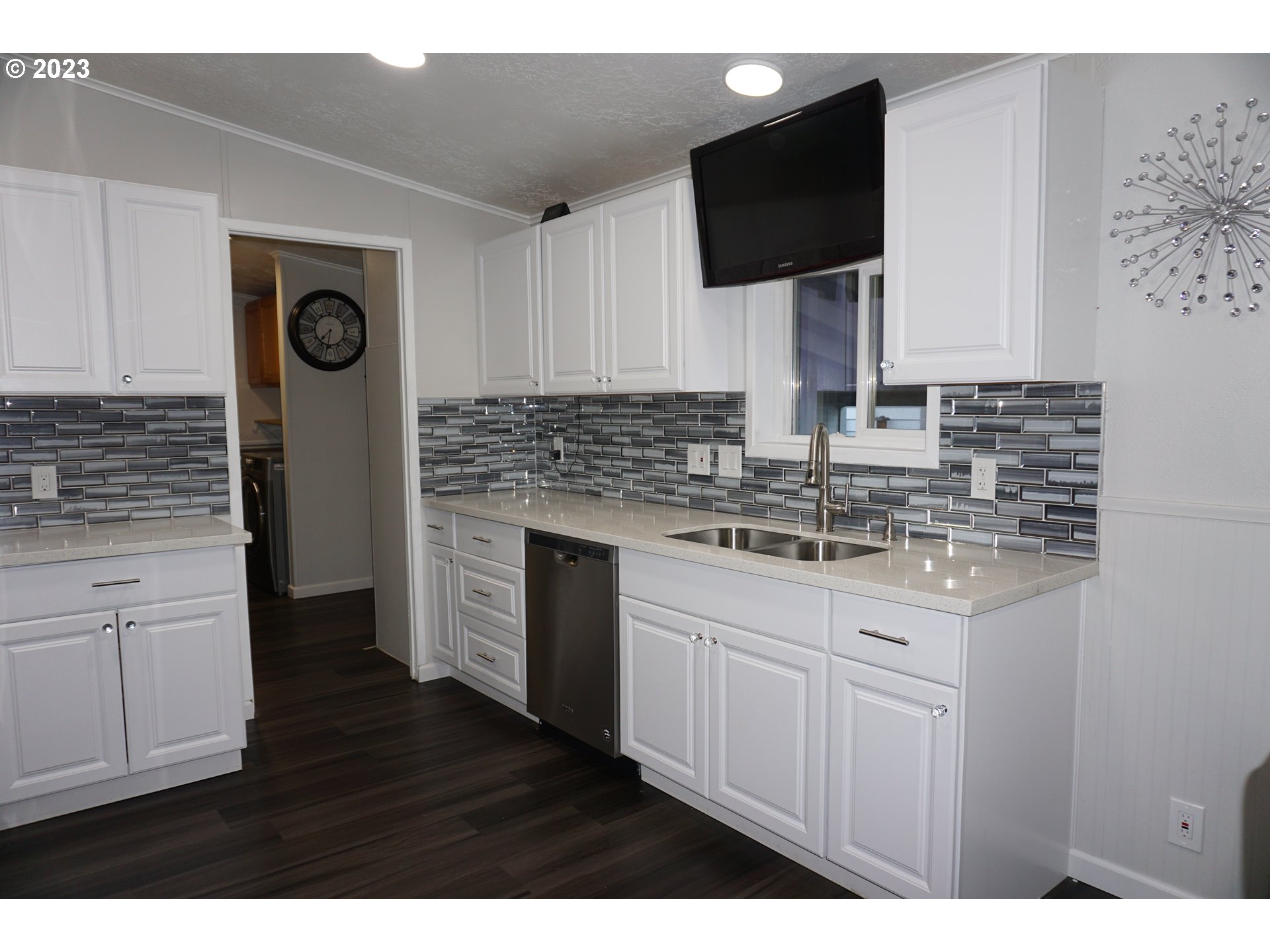 1949 Southeast Palmquist Road Gresham, OR 97080 - Photo 7 of 31 a kitchen with stainless steel appliances granite countertop a sink stove and microwave