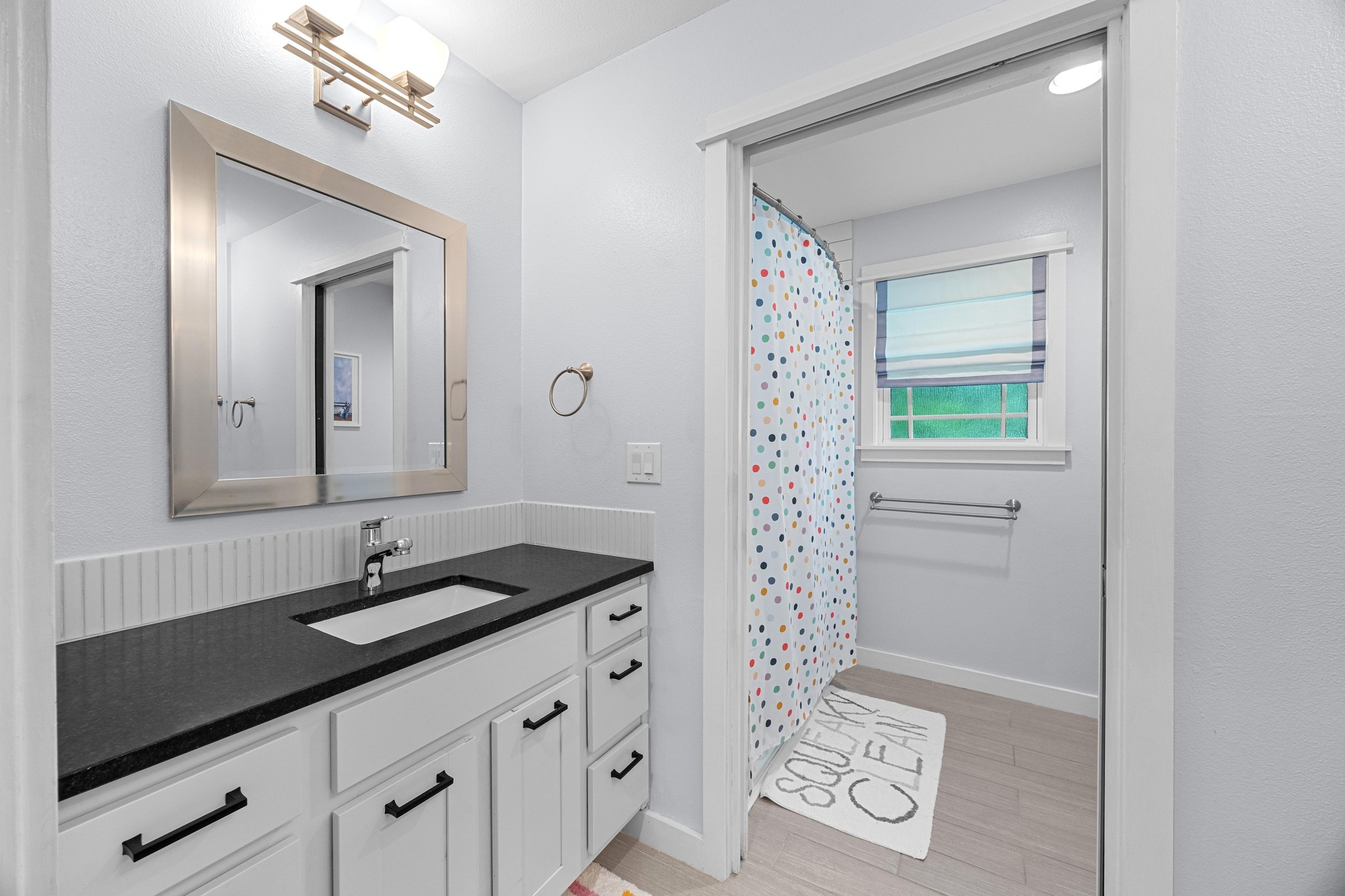 3907 Becker Avenue Austin, TX 78751 - Photo 26 of 37 Full bath with shower, two separate vanities, and tile floors.