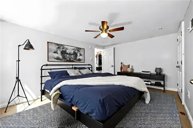 a bedroom with bed and a chandelier