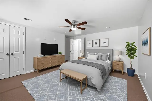 a spacious bedroom with a bed and a flat screen tv