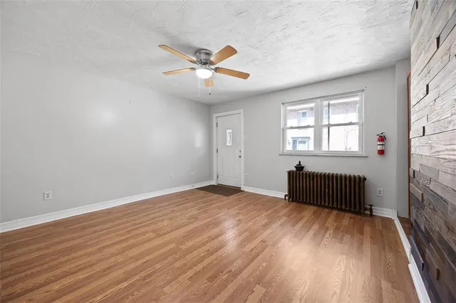 wooden floor in an empty room with a window