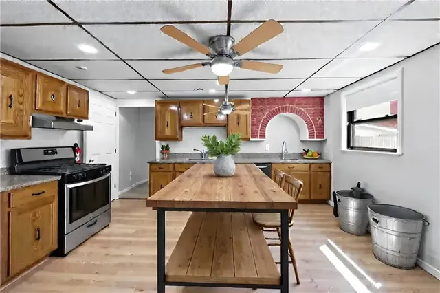 a kitchen with a table chairs stove and refrigerator