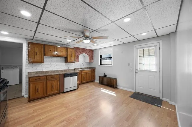 a large kitchen with stainless steel appliances granite countertop a sink and cabinets