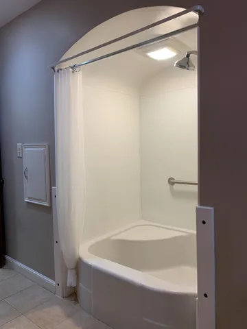 a bathroom with a bathtub and a shower