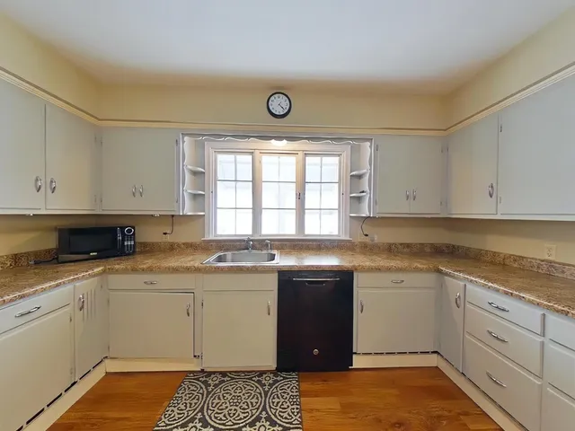 a kitchen with a sink stove and cabinets