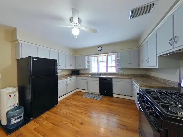 a kitchen with a refrigerator and window