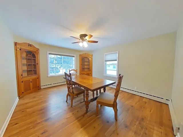 a view of a livingroom with furniture window and wooden floor