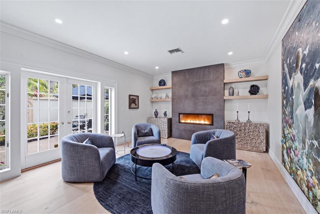 512 Turtle Hatch Road Naples, FL 34103 - Photo 5 of 18 Living room accented by a Fireplace and floating shelves