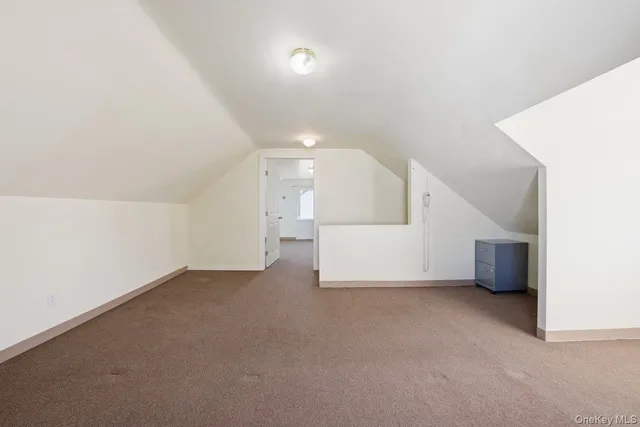 a view of an empty room with a kitchen