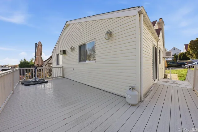 a view of a house with wooden deck