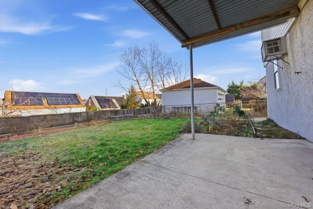 a view of a chair and table in the garden