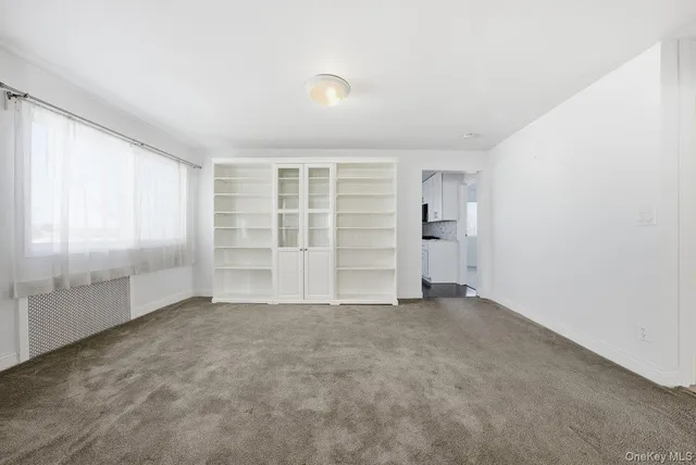 an empty room with a empty space and windows