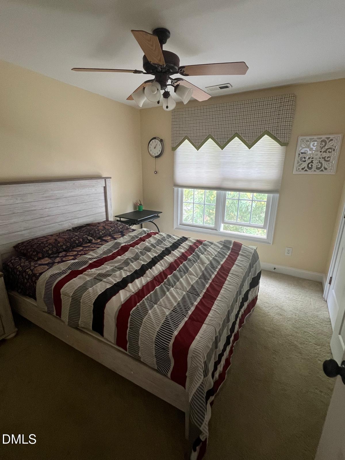 133 Fort Jackson Road Morrisville, NC 27560 - Photo 13 of 25 a bedroom with a bed and window